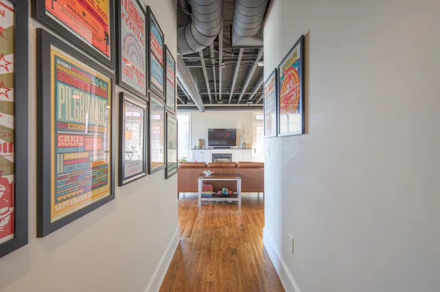 a view of a house with dining room and wooden floor