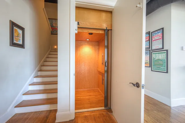 a view of a hallway with wooden floor and entryway