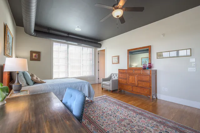 a bedroom with furniture and wooden floor