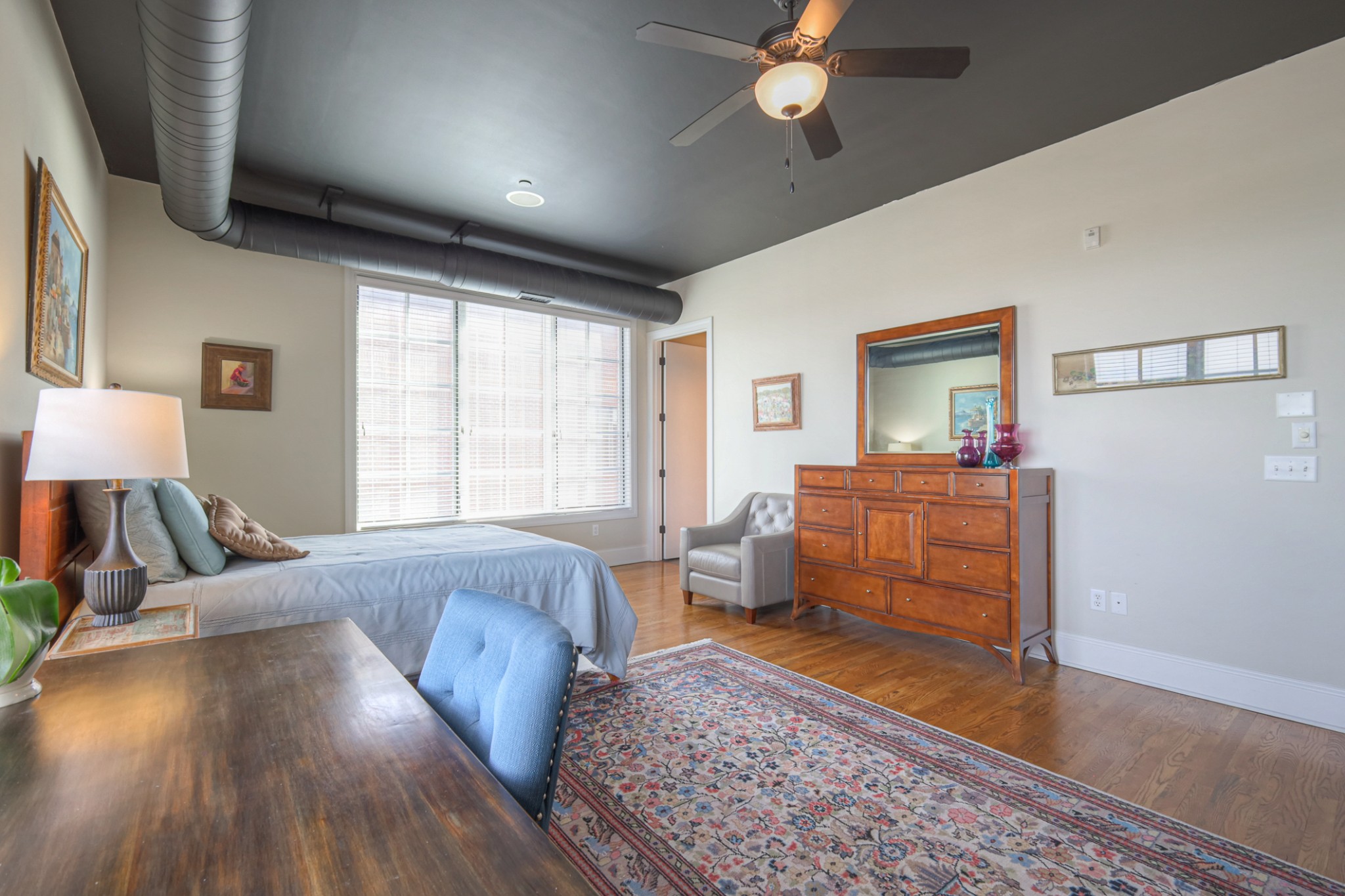 320 Liberty Pike, Unit 214 Franklin, TN 37064 - Photo 21 of 53 a bedroom with furniture and wooden floor