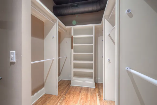 a view of walk in closet with empty racks