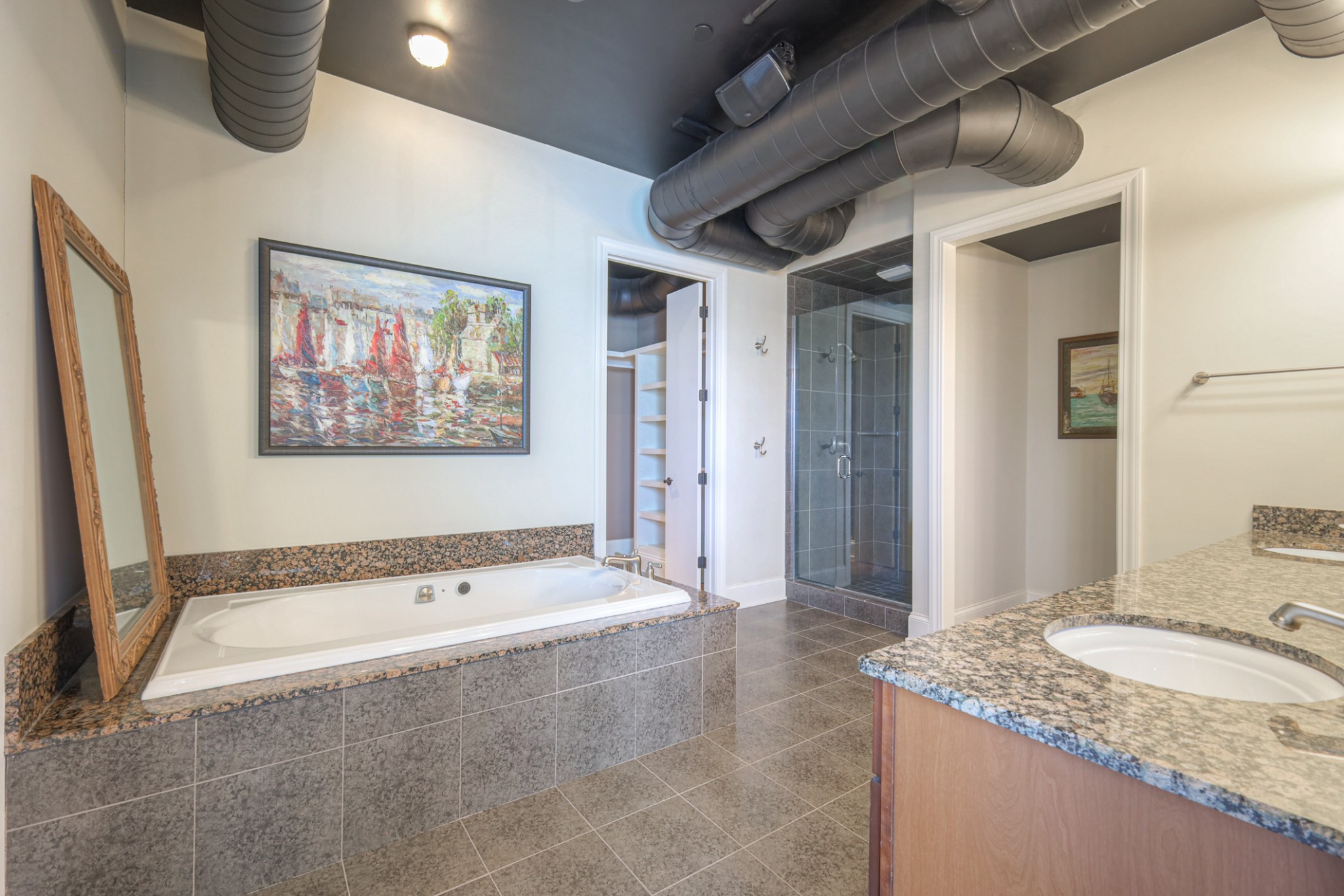 320 Liberty Pike, Unit 214 Franklin, TN 37064 - Photo 23 of 53 a bathroom with a granite countertop tub sink and mirror