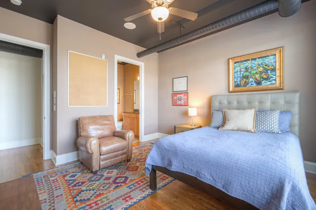 a bedroom with a bed and a couch