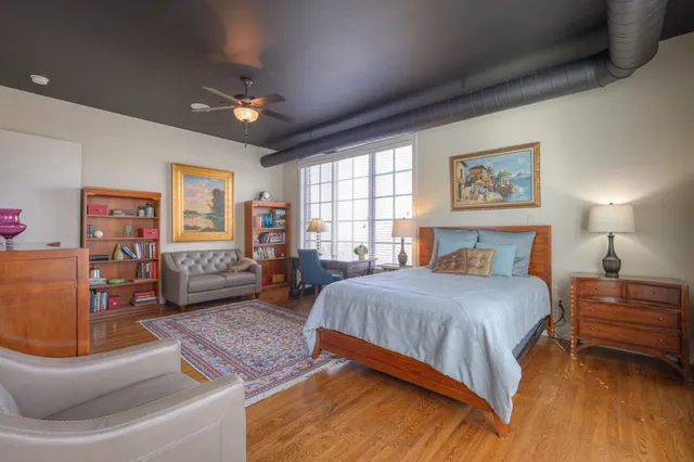 a bedroom with a bed window and couch