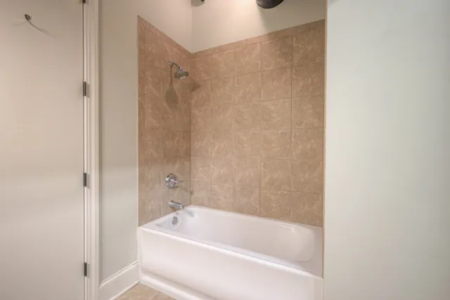 a bathroom with a tub and shower