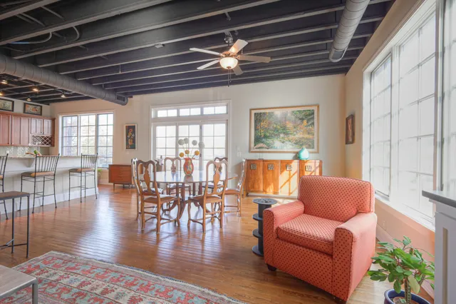 a living room with furniture wooden floor and dining table