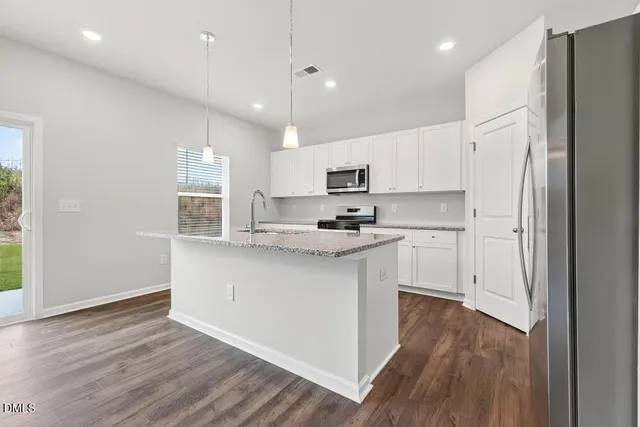 a kitchen with granite countertop cabinets and window