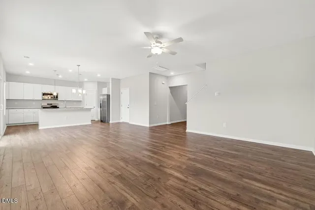 a kitchen with a refrigerator and a stove top oven