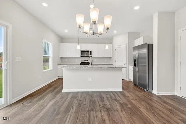 a view of a kitchen with a stove kitchen view and wooden floor