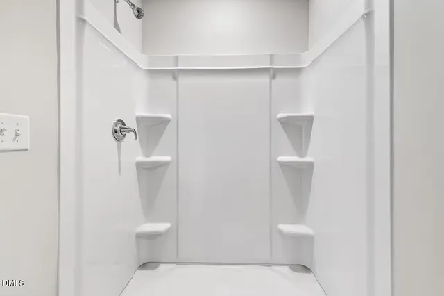 a white toilet sitting next to a white sink