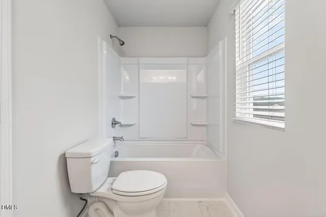 a bathroom with a granite countertop toilet a sink and bathtub