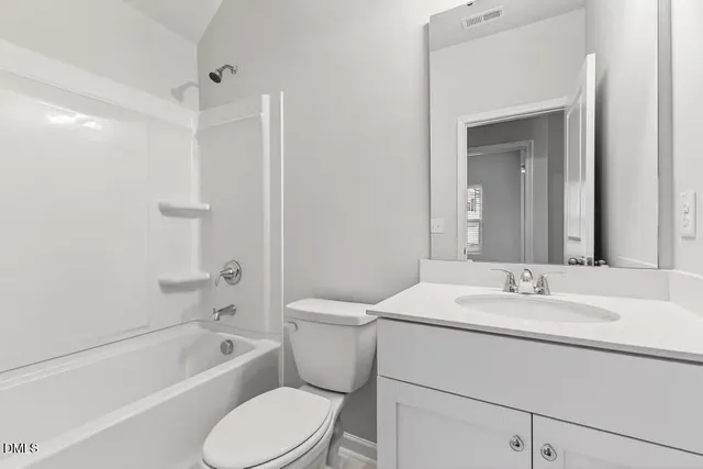 a bathroom with a sink toilet vanity and shower