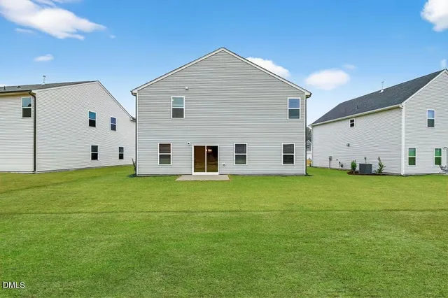 a view of a white house with a yard