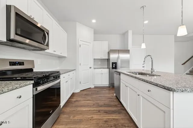 a view of a white house with a big yard