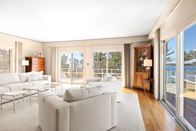 a living room with furniture and large windows