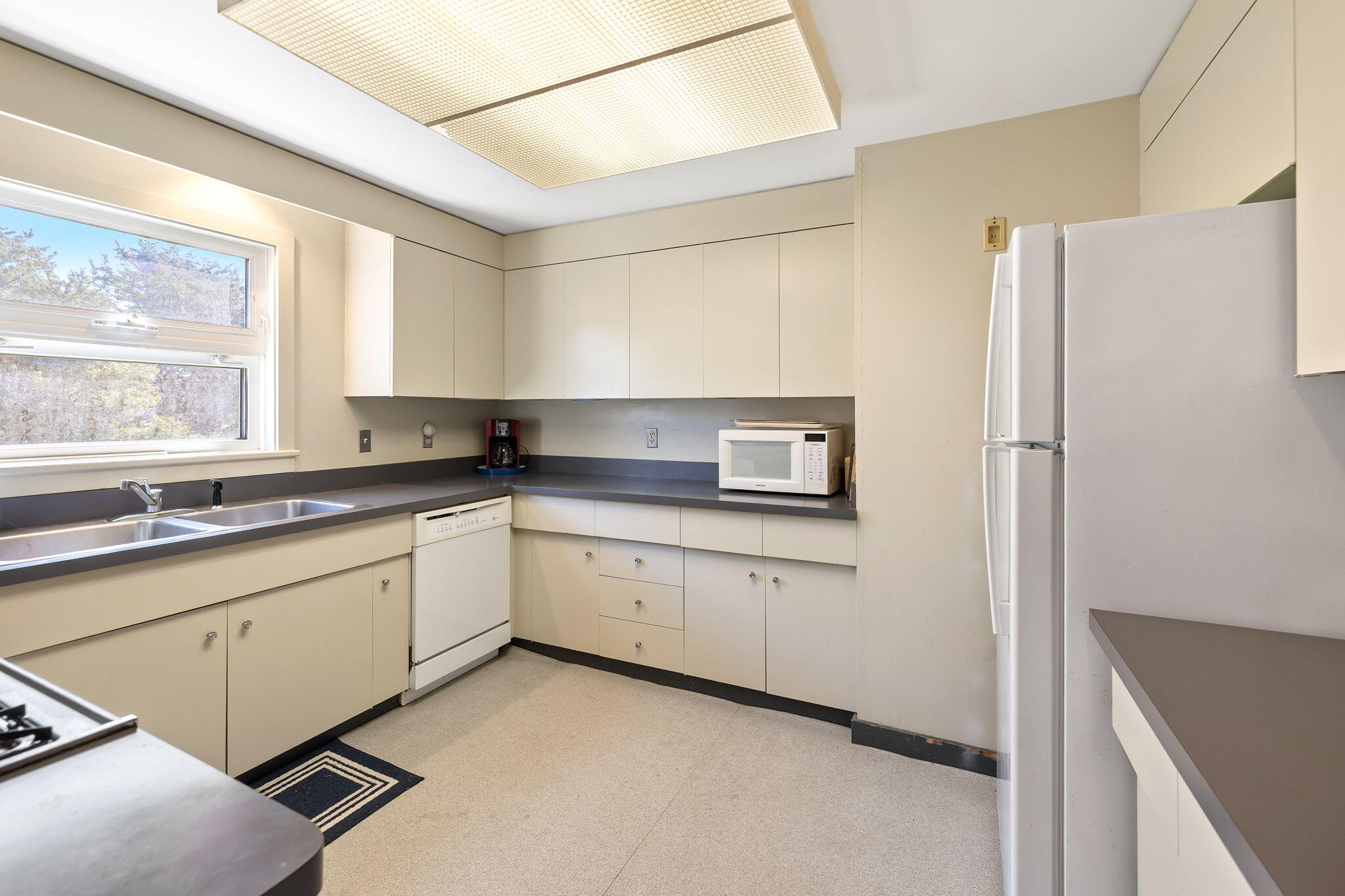 169 Penzance Road Woods Hole, MA 02543 - Photo 18 of 41 a kitchen with stainless steel appliances granite countertop a refrigerator and a sink