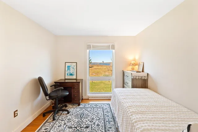 a bedroom with a bed and a chair