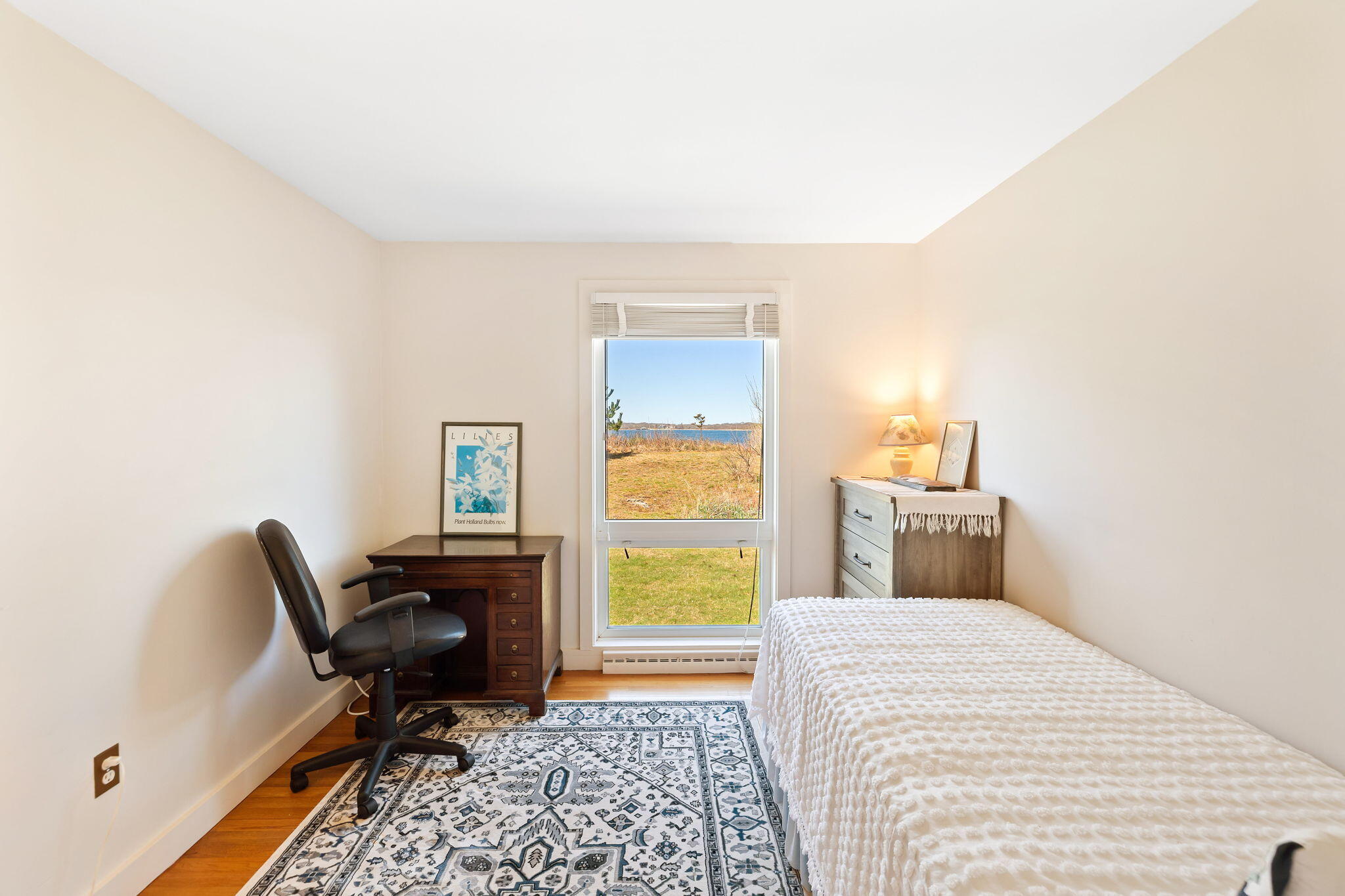 169 Penzance Road Woods Hole, MA 02543 - Photo 26 of 41 a bedroom with a bed and a chair