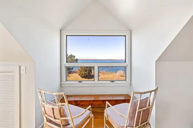 a view of a dining room with furniture and a window