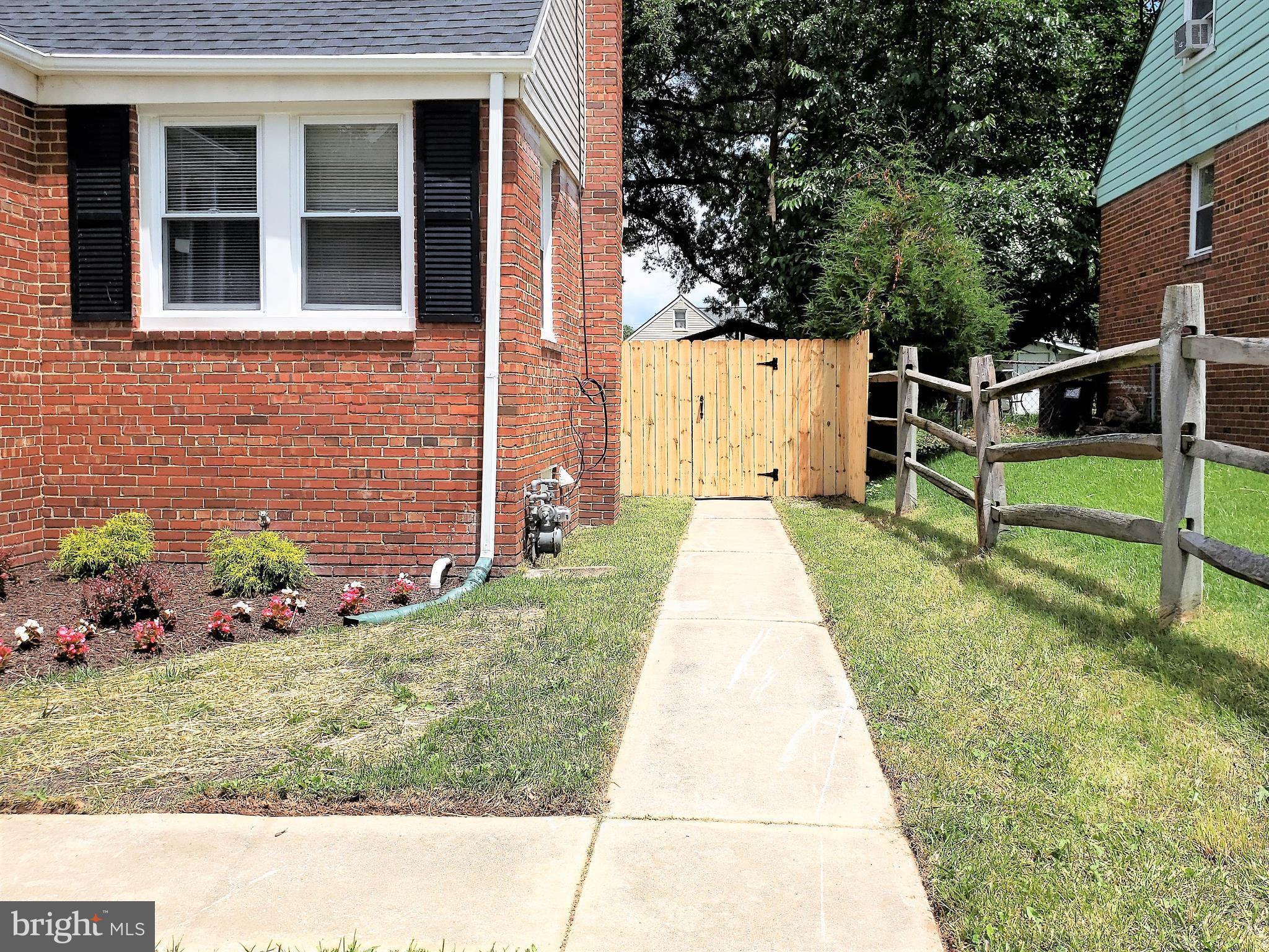 4709 68th Avenue Hyattsville, MD 20784 - Photo 2 of 30 a view of backyard with wooden fence and a bench
