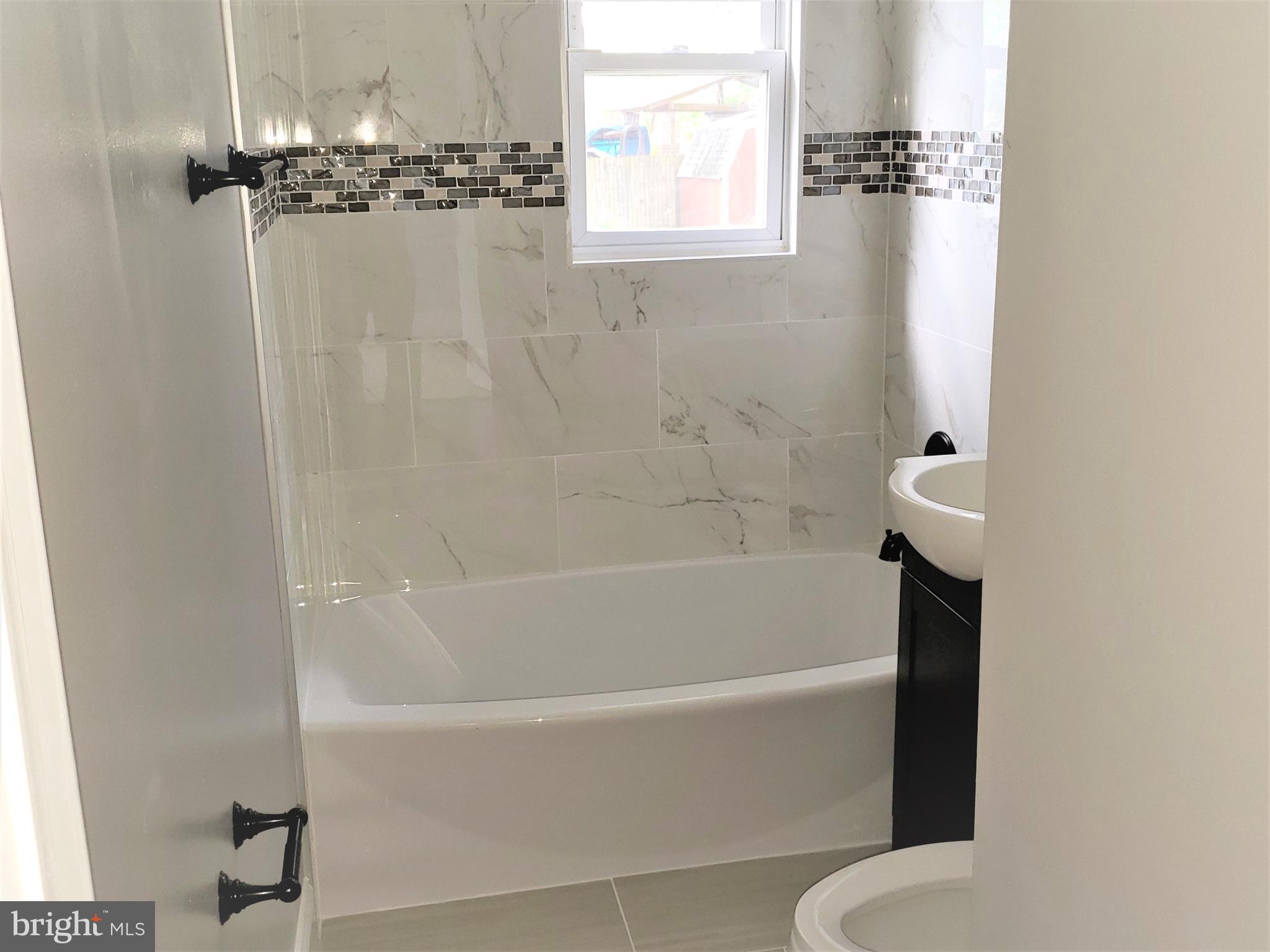 4709 68th Avenue Hyattsville, MD 20784 - Photo 13 of 30 a white bath tub sitting next to a white tub