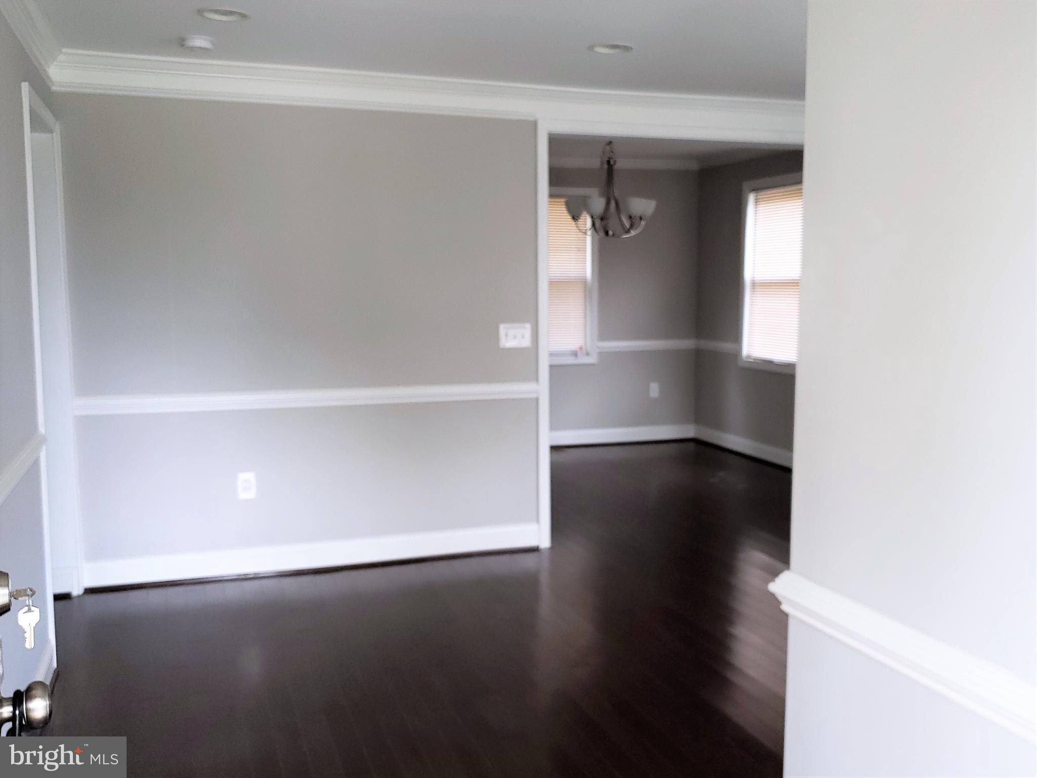 4709 68th Avenue Hyattsville, MD 20784 - Photo 3 of 30 a view of empty room with wooden floor and fan