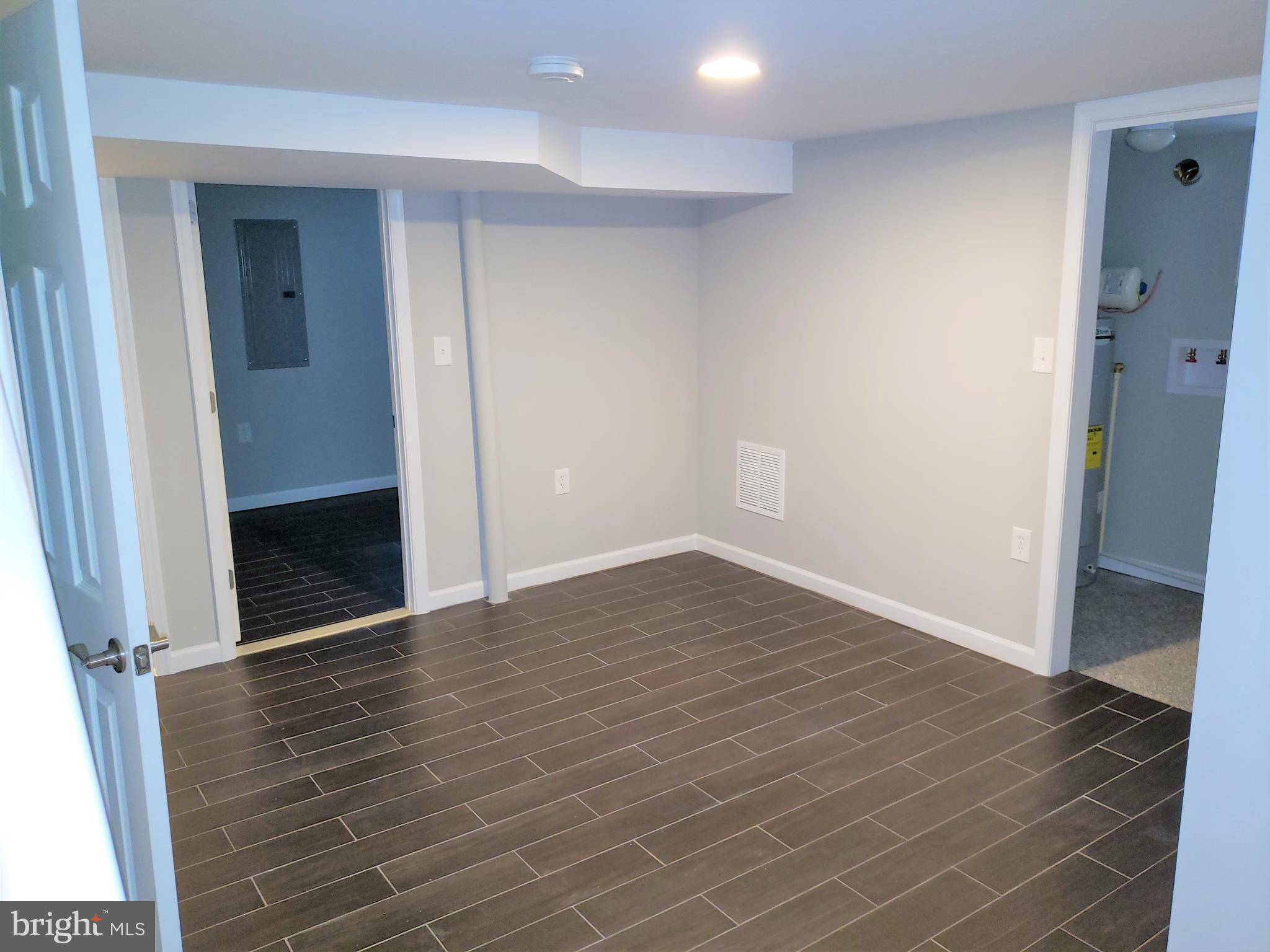 4709 68th Avenue Hyattsville, MD 20784 - Photo 26 of 30 an empty room with wooden floor and entrance