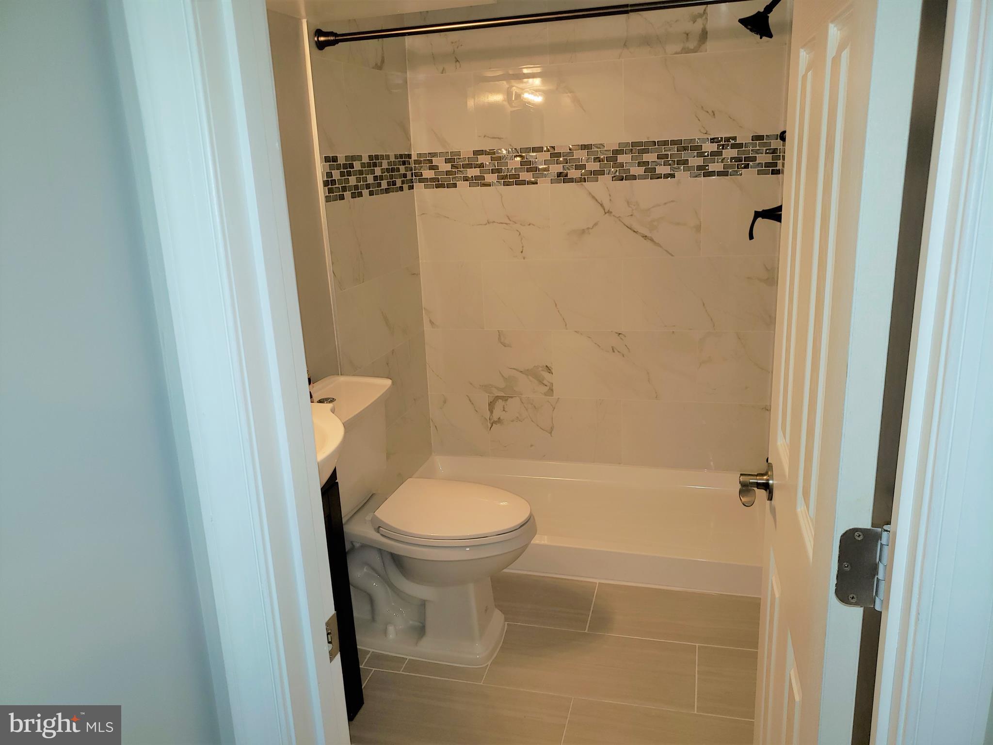 4709 68th Avenue Hyattsville, MD 20784 - Photo 30 of 30 a bathroom with a shower a toilet and a shower