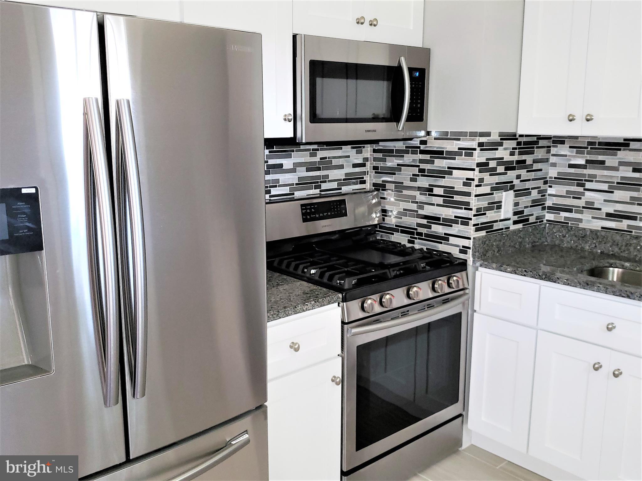 4709 68th Avenue Hyattsville, MD 20784 - Photo 7 of 30 a kitchen with a stove and a microwave