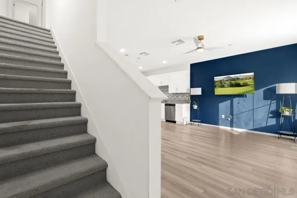 a view of entryway and hall with wooden floor