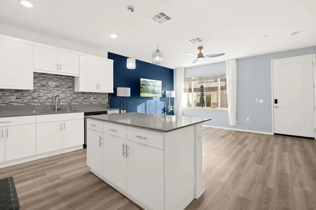 347 Sweet Place Fallbrook, CA 92028 - Photo 21 of 33 a kitchen with granite countertop a sink cabinets and wooden floor