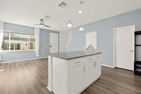 an empty room with wooden floor and window