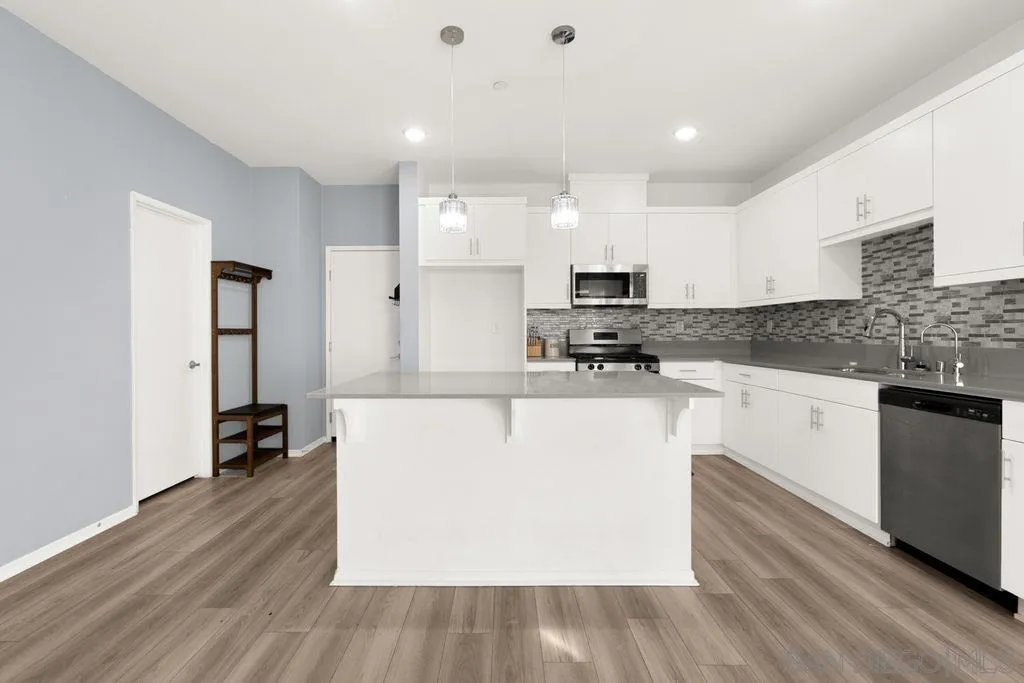 347 Sweet Place Fallbrook, CA 92028 - Photo 25 of 33 a kitchen with stainless steel appliances a refrigerator sink and white cabinets