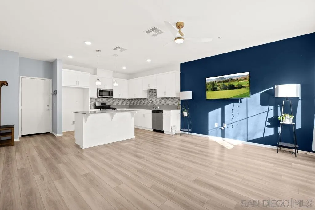 347 Sweet Place Fallbrook, CA 92028 - Photo 26 of 33 a view of kitchen with refrigerator microwave and wooden floor