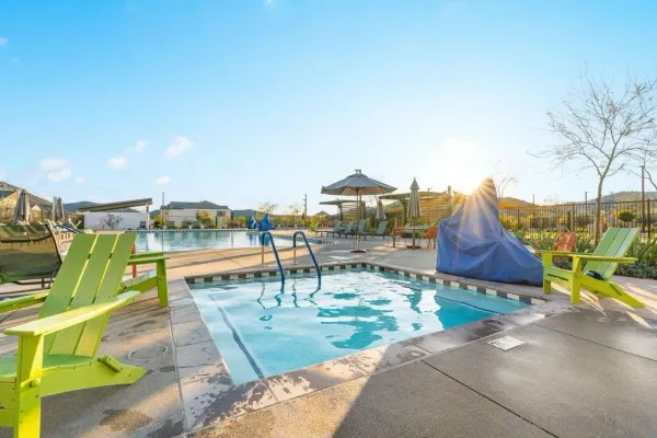 a view of a swimming pool and lounge chairs
