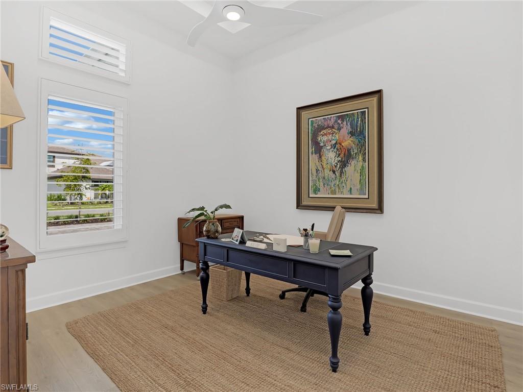 15432 Turin Drive Naples, FL 34114 - Photo 11 of 45 a view of a workspace with furniture and a window