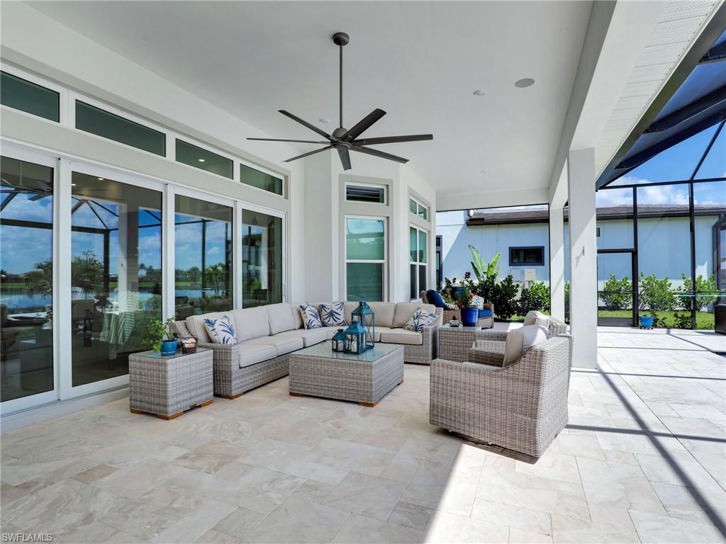 15432 Turin Drive Naples, FL 34114 - Photo 12 of 45 a living room with furniture and a large window