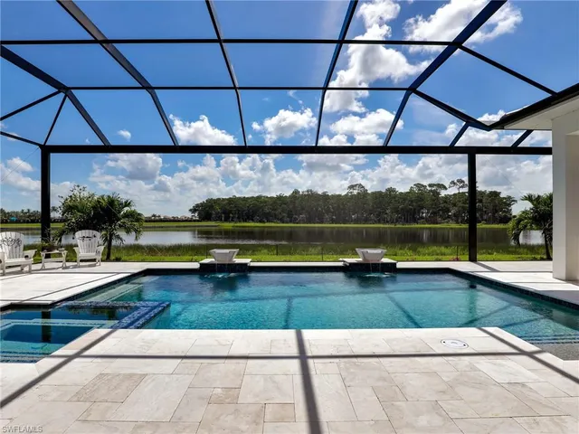 a view of swimming pool with yard in front of it