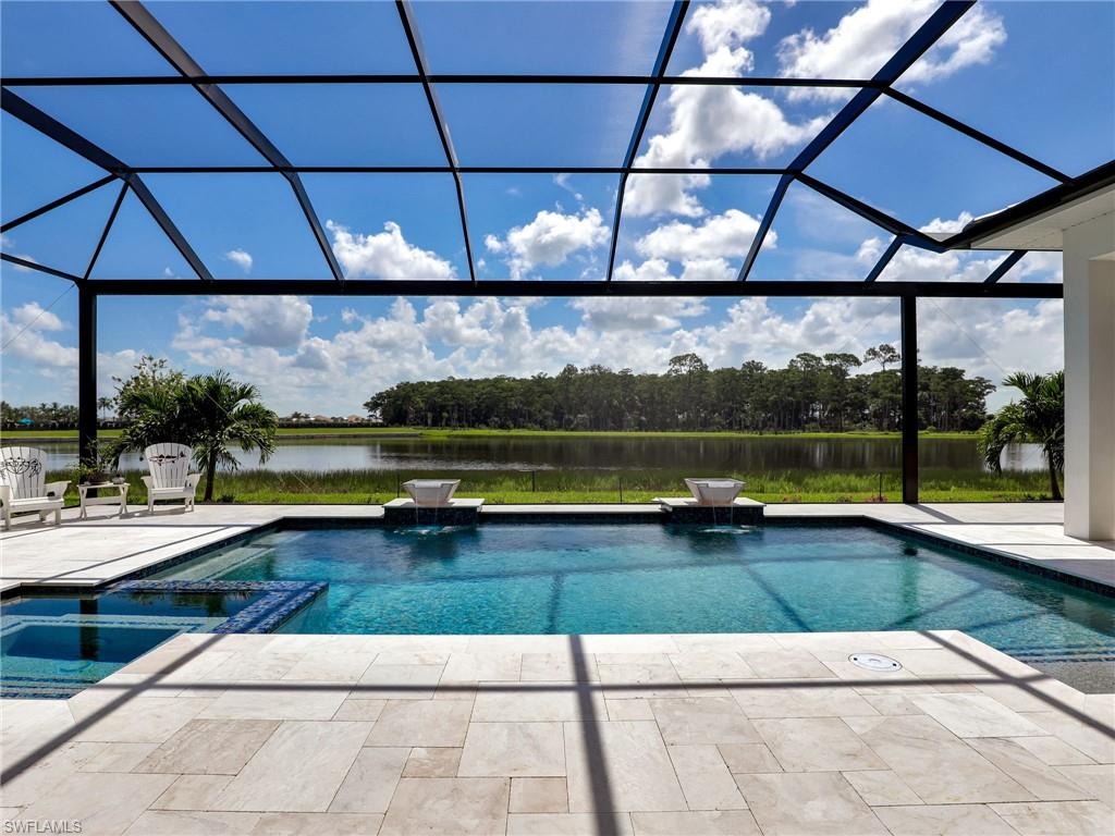 15432 Turin Drive Naples, FL 34114 - Photo 13 of 45 a view of swimming pool with yard in front of it