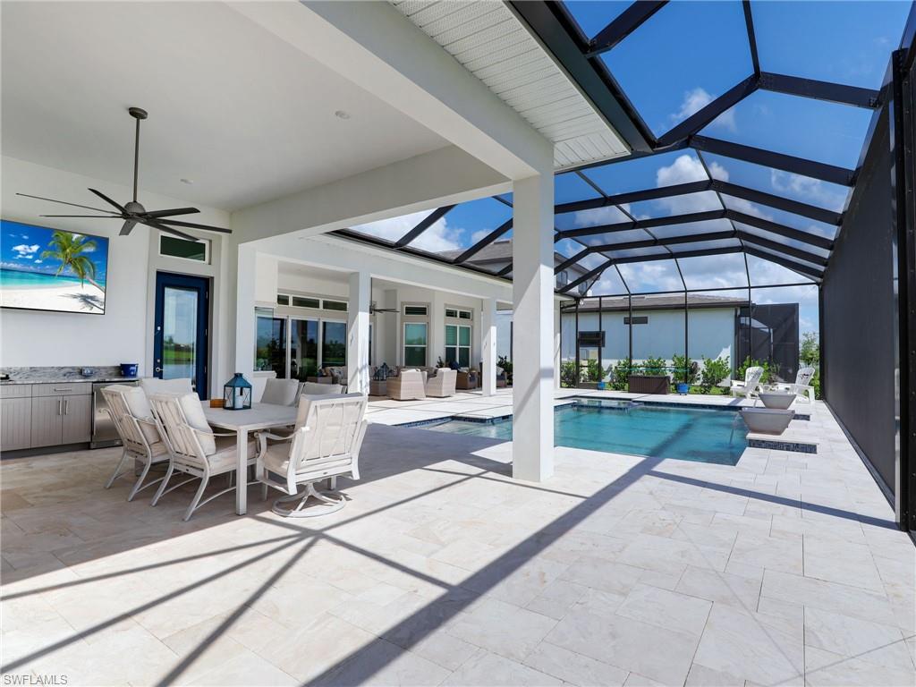 15432 Turin Drive Naples, FL 34114 - Photo 16 of 45 a view of a patio with a dining table and chairs