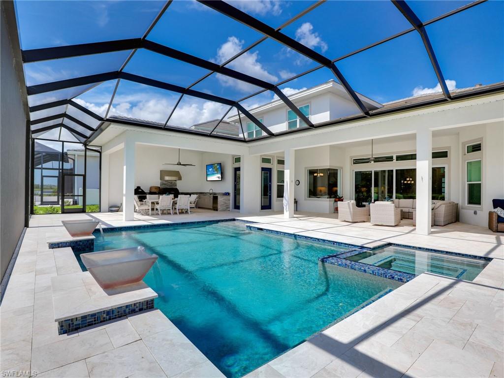 15432 Turin Drive Naples, FL 34114 - Photo 17 of 45 a view of swimming pool with outdoor seating