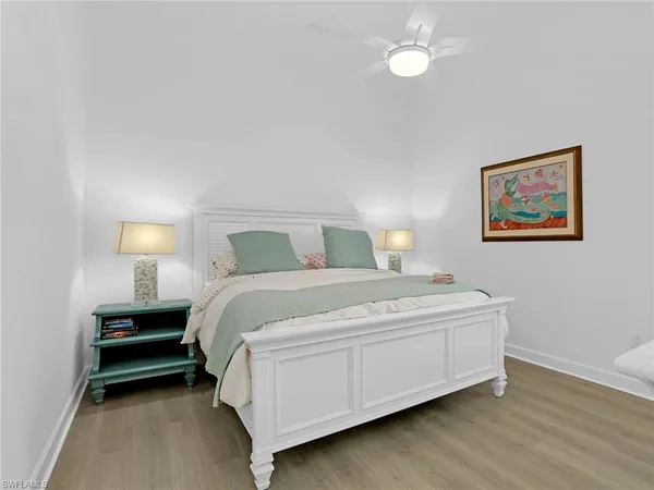 a bedroom with a bed and lamp
