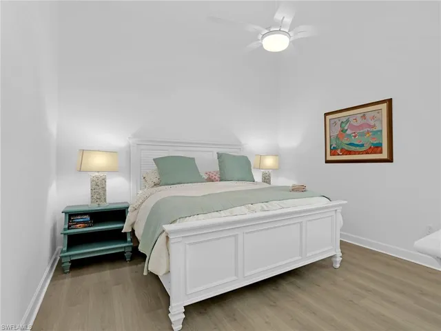 a bedroom with a bed and lamp