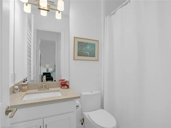 a bathroom with a sink a toilet and mirror