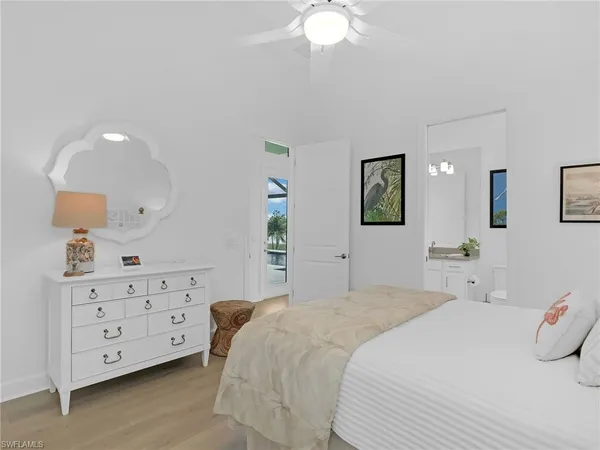 a bedroom with a bed a dresser and night lamp