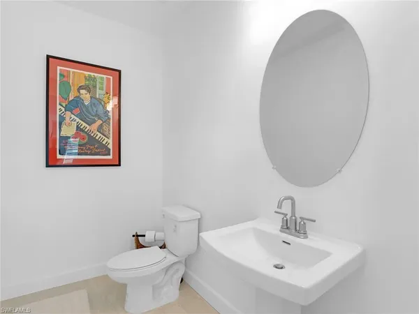 a bedroom with bed and a chandelier