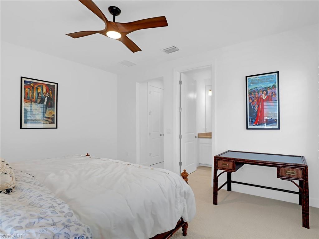 15432 Turin Drive Naples, FL 34114 - Photo 32 of 45 a bedroom with a bed and a desk
