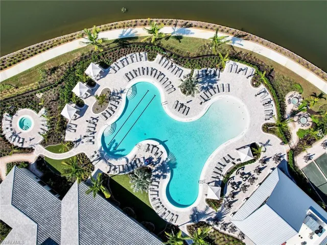 an aerial view of a swimming pool with an outdoor seating