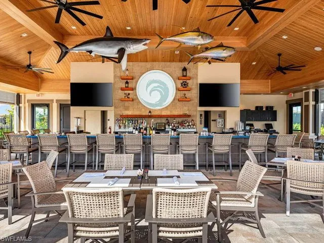 a living room with furniture and large windows