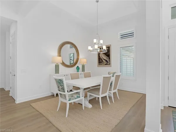 a view of a dining room with furniture and chandelier